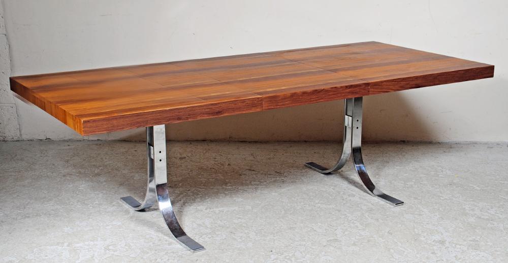 A HARDWOOD AND CHROME PLATED EXTENDING DINING TABLE in the manner of Milo Baughman Image