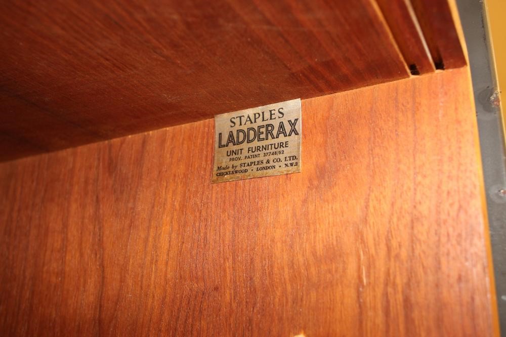 A LADDERAX TEAK UNIT comprising a cupboard with two sliding doors enclosing shelving Image
