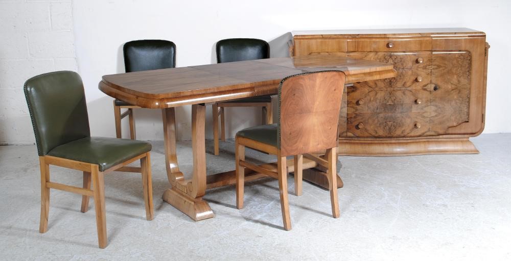 AN ART DECO BURR WALNUT DINING SUITE comprising extending dining table of rounded oblong form with Image