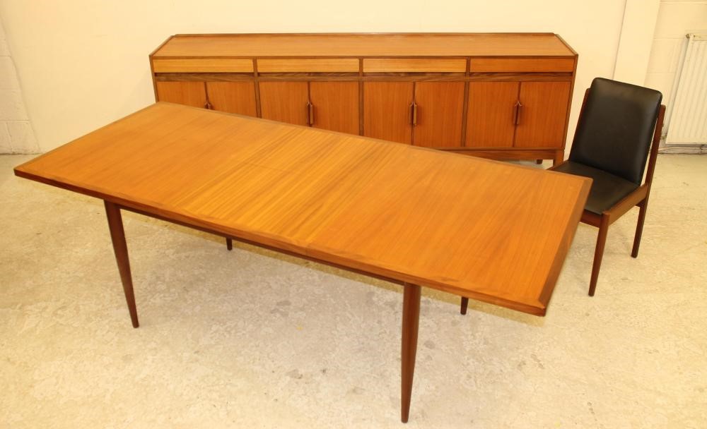 A TEAK AND ROSEWOOD BANDED DINING SUITE Image