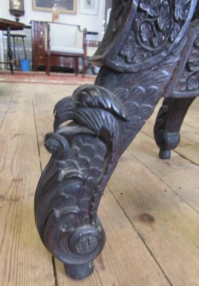 A BURMESE CARVED HARDWOOD CENTRE TABLE of octagonal form with pierced frieze Image