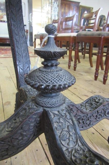 A BURMESE CARVED HARDWOOD CENTRE TABLE of octagonal form with pierced frieze Image