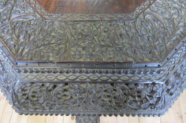 A BURMESE CARVED HARDWOOD CENTRE TABLE of octagonal form with pierced frieze Image