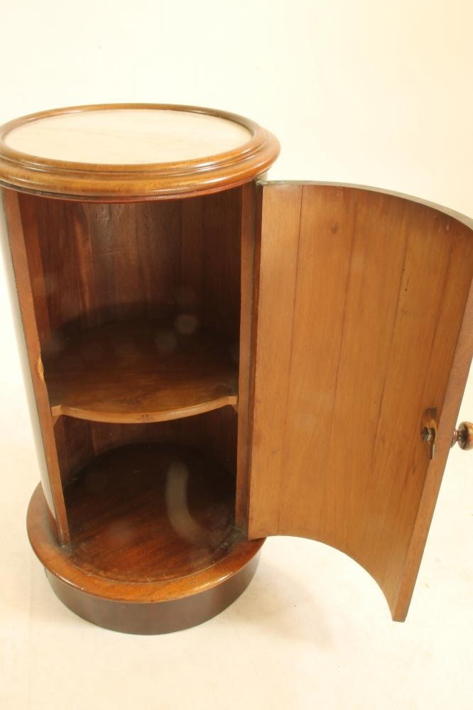 A VICTORIAN MAHOGANY BEDSIDE CUPBOARD of cylindrical form with inset white marble top Image