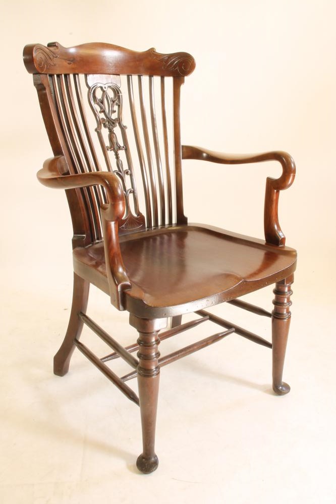 A CARVED MAHOGANY ELBOW CHAIR Image