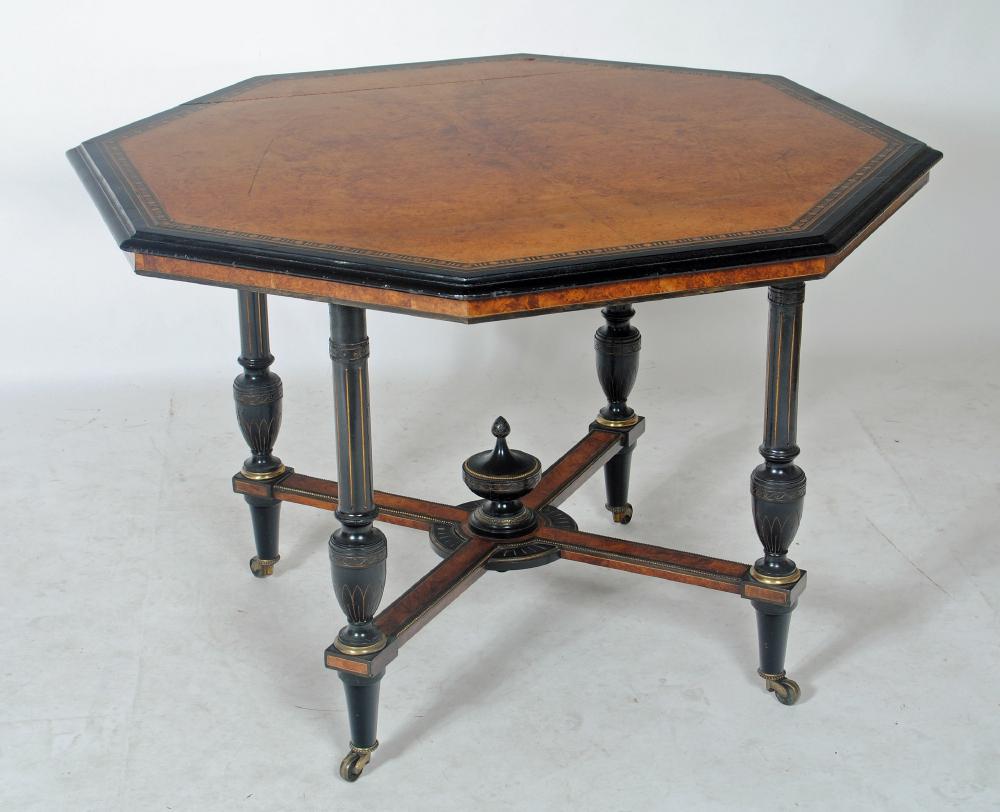 AN AESTHETIC AMBOYNA AND EBONISED CENTRE TABLE of octagonal form with parcel gilding Image