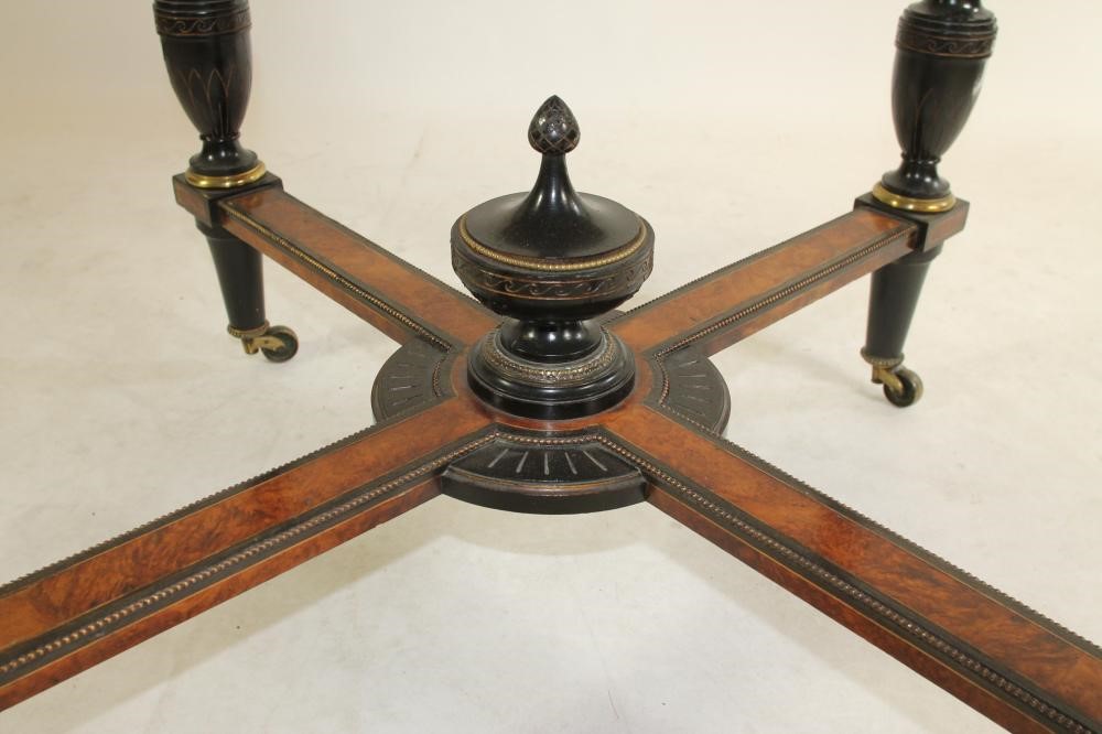 AN AESTHETIC AMBOYNA AND EBONISED CENTRE TABLE of octagonal form with parcel gilding Image
