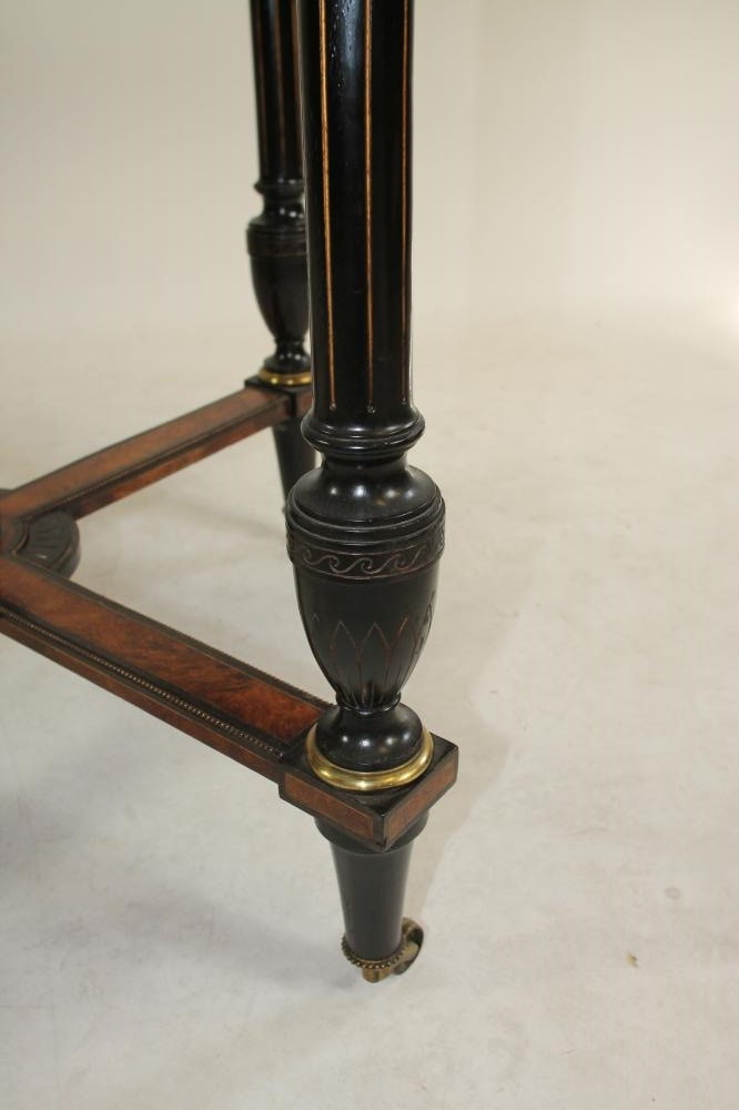 AN AESTHETIC AMBOYNA AND EBONISED CENTRE TABLE of octagonal form with parcel gilding Image