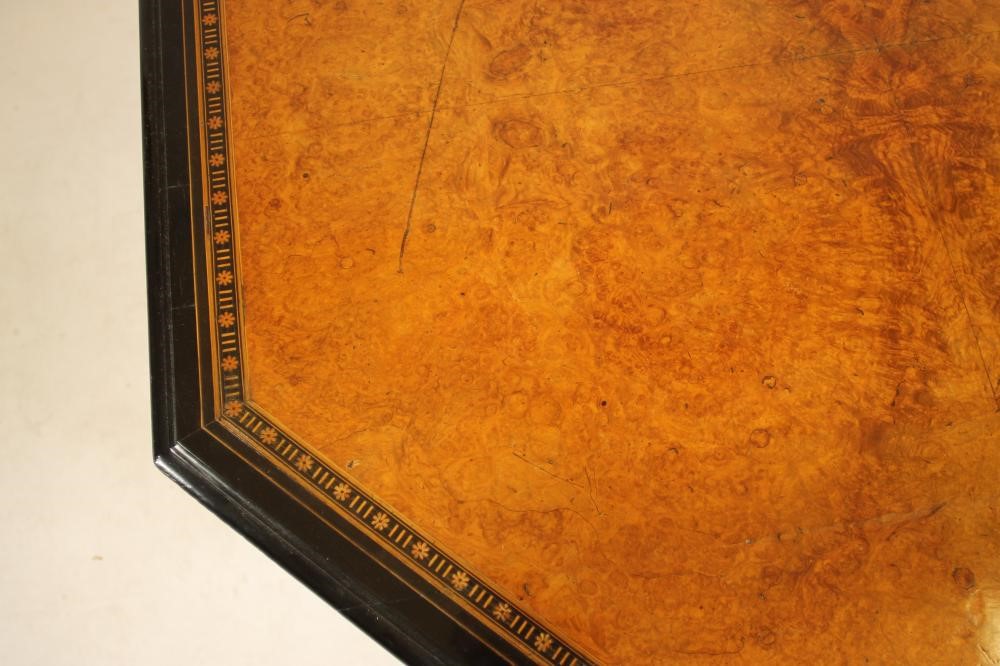 AN AESTHETIC AMBOYNA AND EBONISED CENTRE TABLE of octagonal form with parcel gilding Image