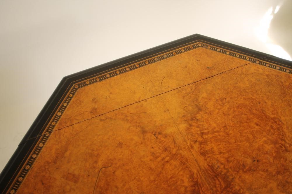 AN AESTHETIC AMBOYNA AND EBONISED CENTRE TABLE of octagonal form with parcel gilding Image