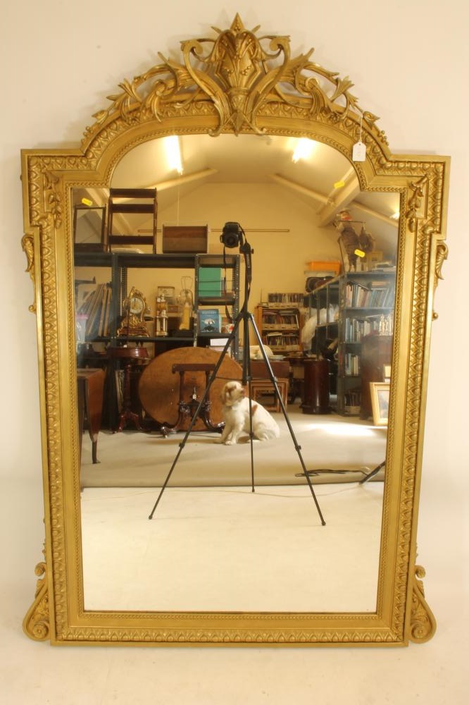 A VICTORIAN GILT WOOD PIER GLASS of arched oblong form with pierced scroll surmount Image