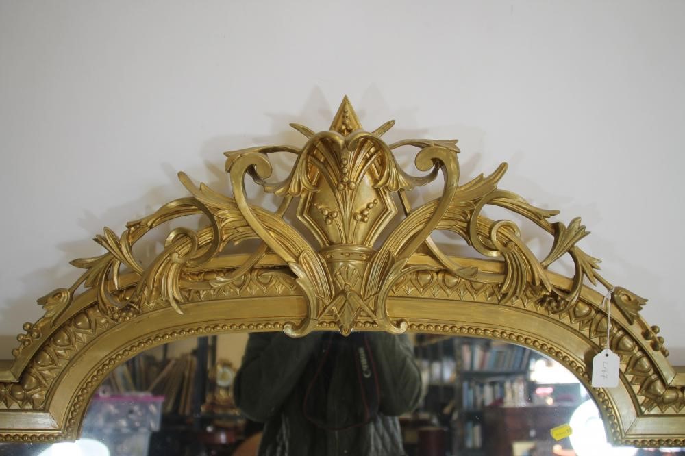 A VICTORIAN GILT WOOD PIER GLASS of arched oblong form with pierced scroll surmount Image