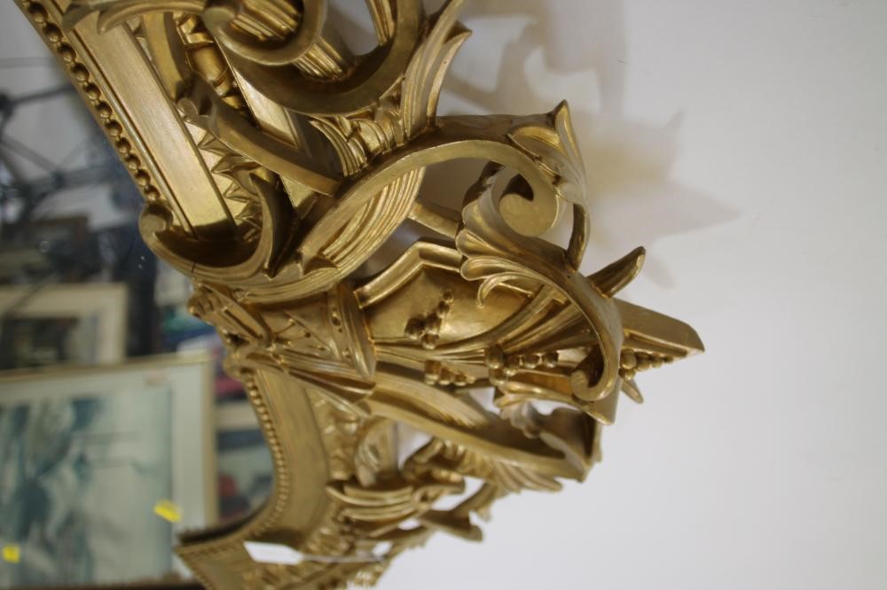 A VICTORIAN GILT WOOD PIER GLASS of arched oblong form with pierced scroll surmount Image