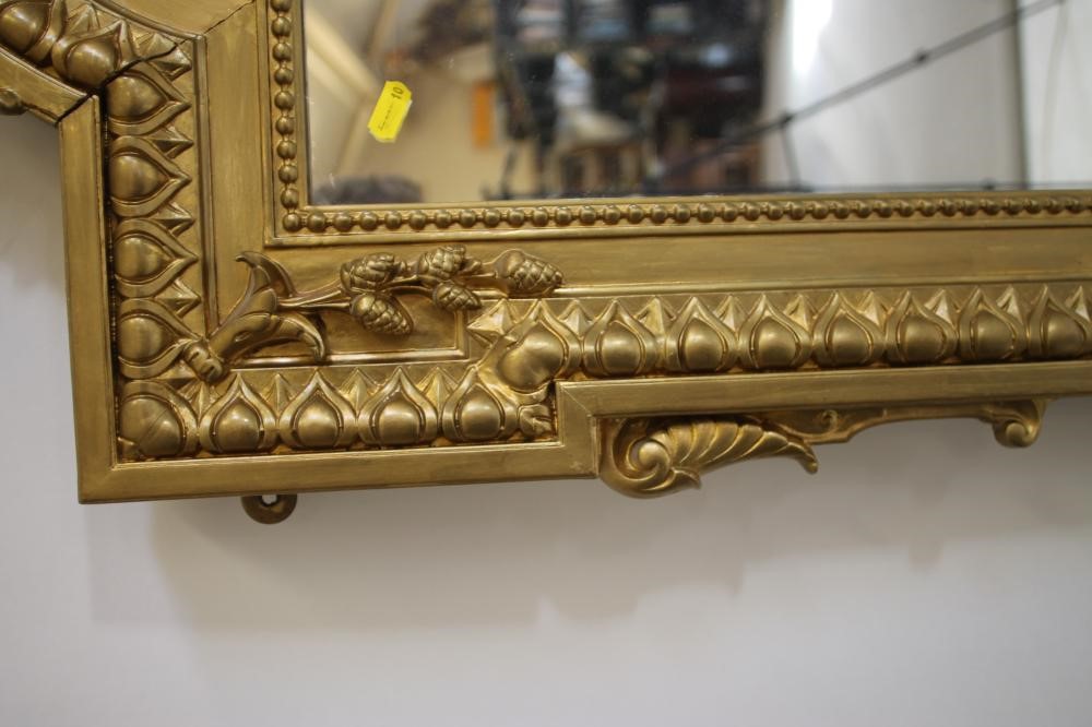 A VICTORIAN GILT WOOD PIER GLASS of arched oblong form with pierced scroll surmount Image