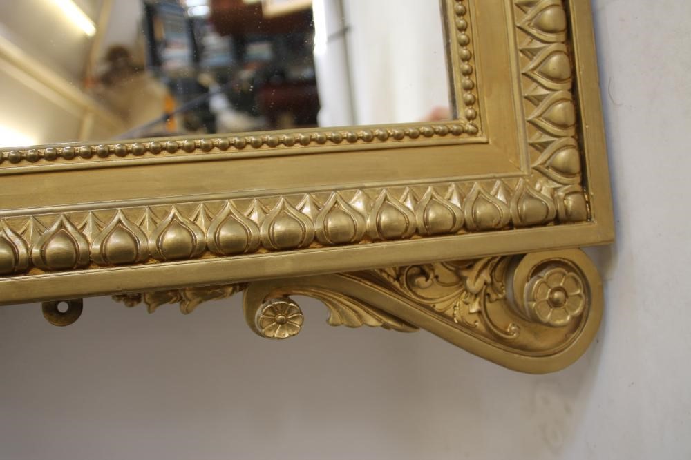A VICTORIAN GILT WOOD PIER GLASS of arched oblong form with pierced scroll surmount Image