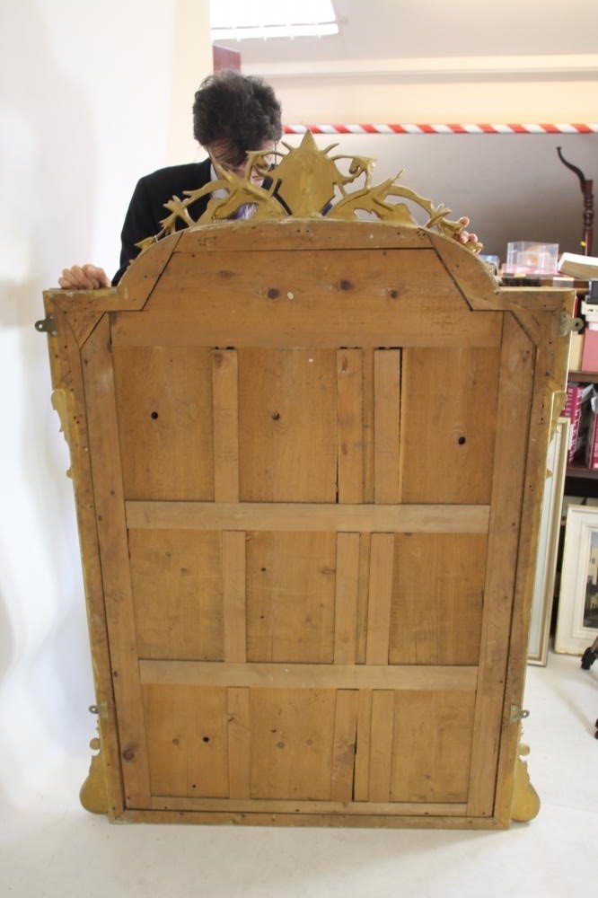 A VICTORIAN GILT WOOD PIER GLASS of arched oblong form with pierced scroll surmount Image