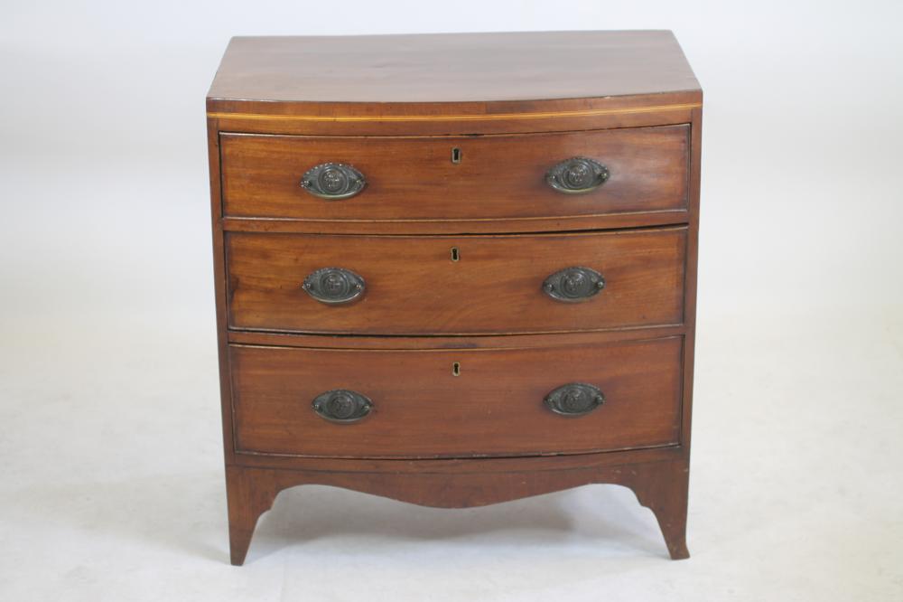 A SMALL MAHOGANY CHEST of bowed form with stringing Image