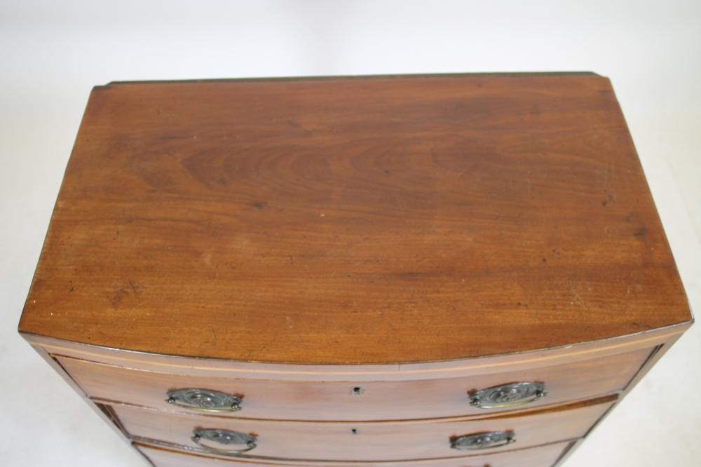 A SMALL MAHOGANY CHEST of bowed form with stringing Image