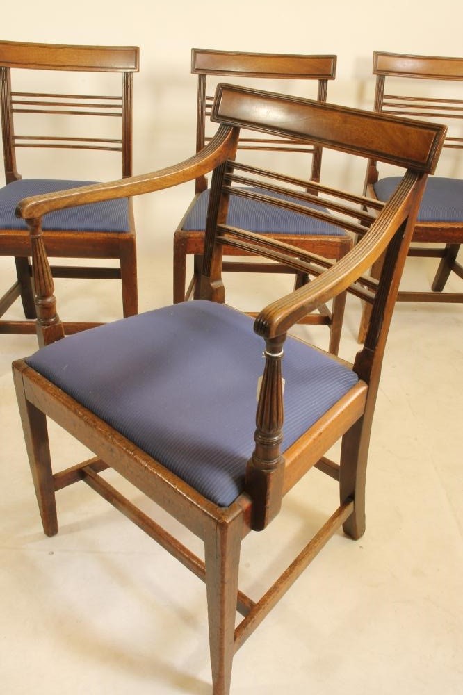 A SET OF FIVE GEORGIAN MAHOGANY DINING CHAIRS including an elbow chair Image
