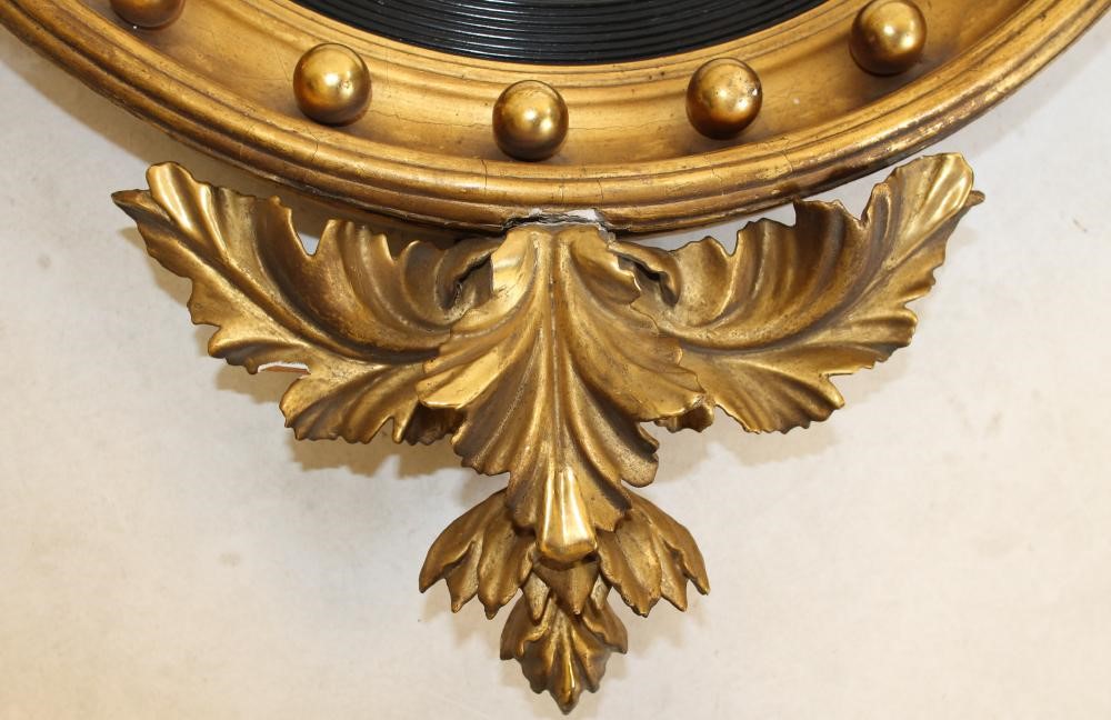 A REGENCY STYLE GILT WOOD CONVEX WALL MIRROR Image