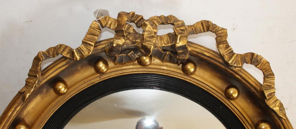 A REGENCY STYLE GILT WOOD CONVEX WALL MIRROR Image