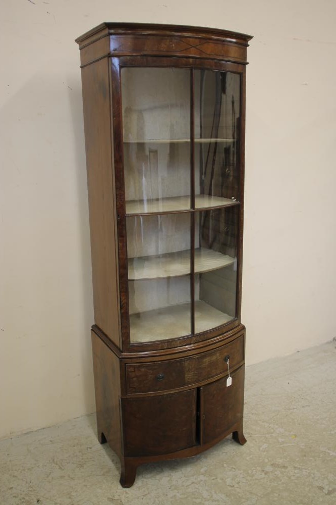 AN EDWARDIAN MAHOGANY DISPLAY CABINET of bowed form with ebony stringing Image