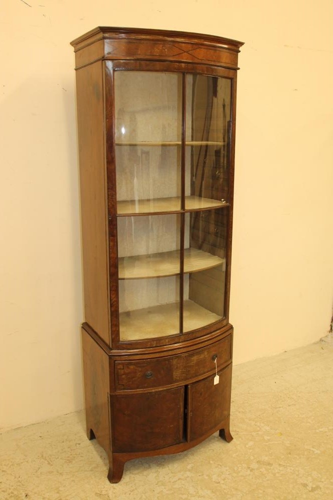 AN EDWARDIAN MAHOGANY DISPLAY CABINET of bowed form with ebony stringing Image