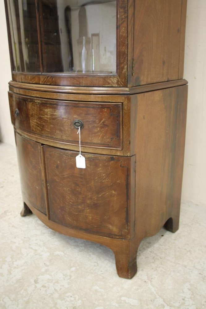 AN EDWARDIAN MAHOGANY DISPLAY CABINET of bowed form with ebony stringing Image