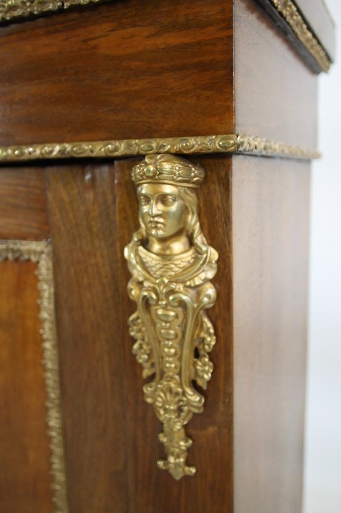 A VICTORIAN WALNUT PIER CABINET of shallow oblong form with gilt metal mounts Image