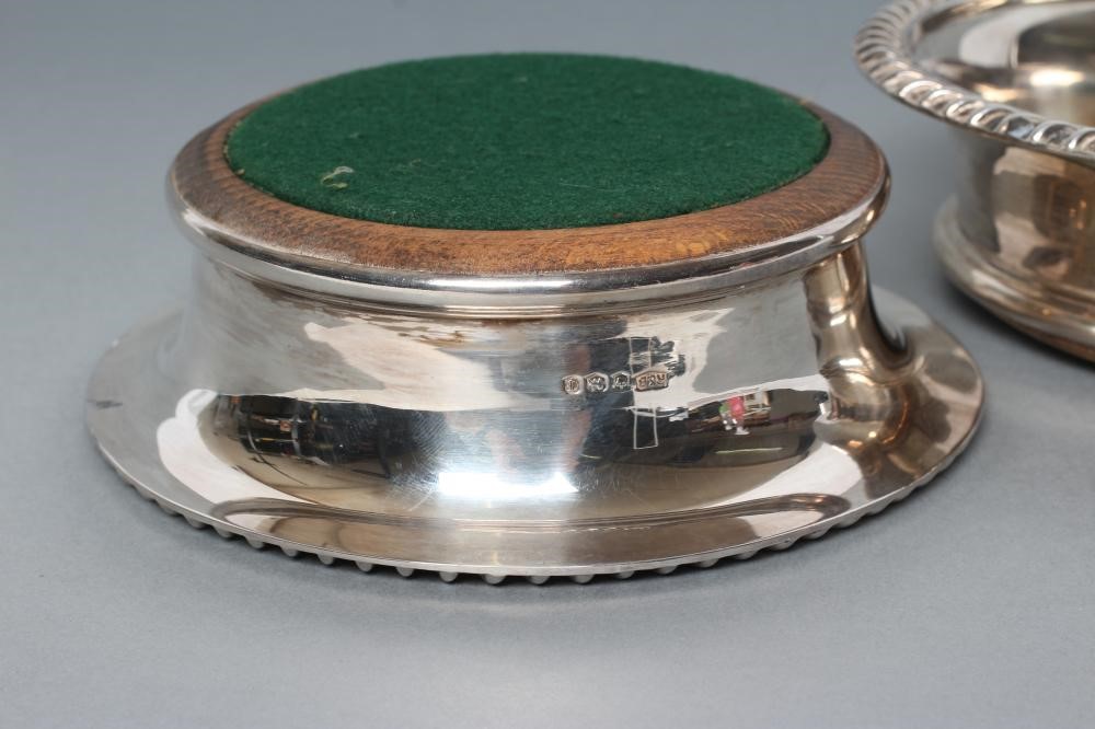A PAIR OF SILVER BOTTLE COASTERS Image