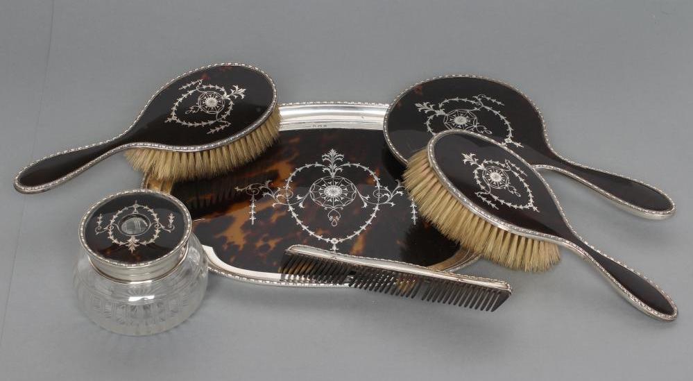 A TORTOISESHELL AND SILVER EIGHT PIECE DRESSING TABLE SET Image