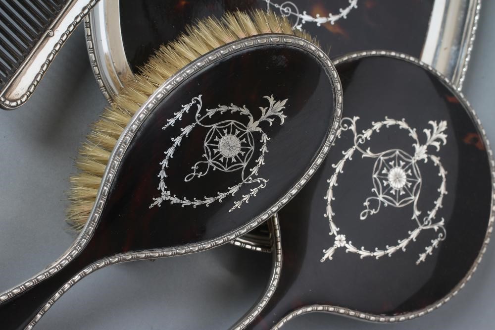 A TORTOISESHELL AND SILVER EIGHT PIECE DRESSING TABLE SET Image