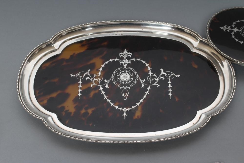 A TORTOISESHELL AND SILVER EIGHT PIECE DRESSING TABLE SET Image