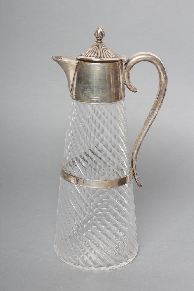 A LATE VICTORIAN SILVER AND GLASS CLARET JUG Image