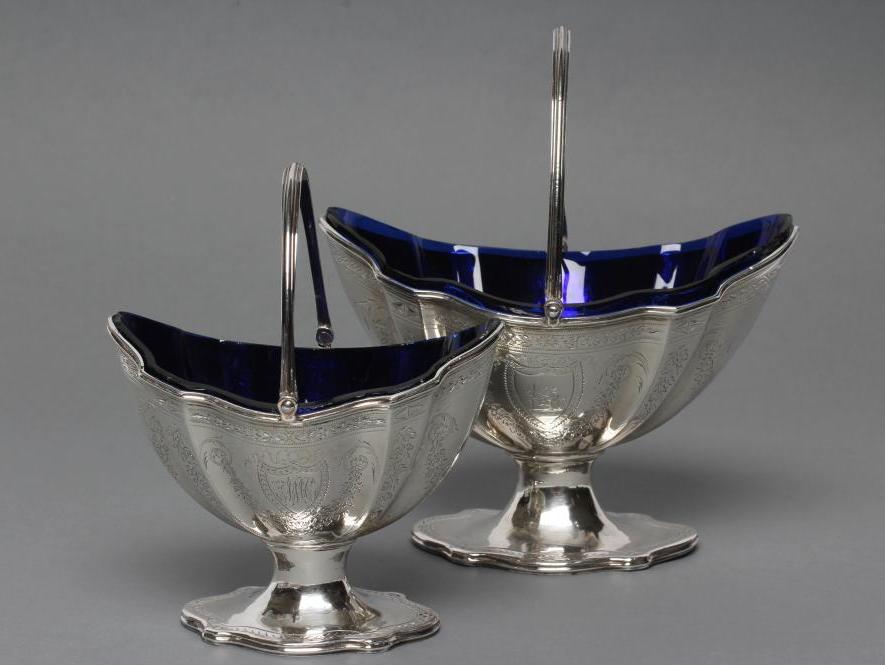A GEORGE III SILVER SUGAR BASKET AND MATCHING CREAM BASKET Image