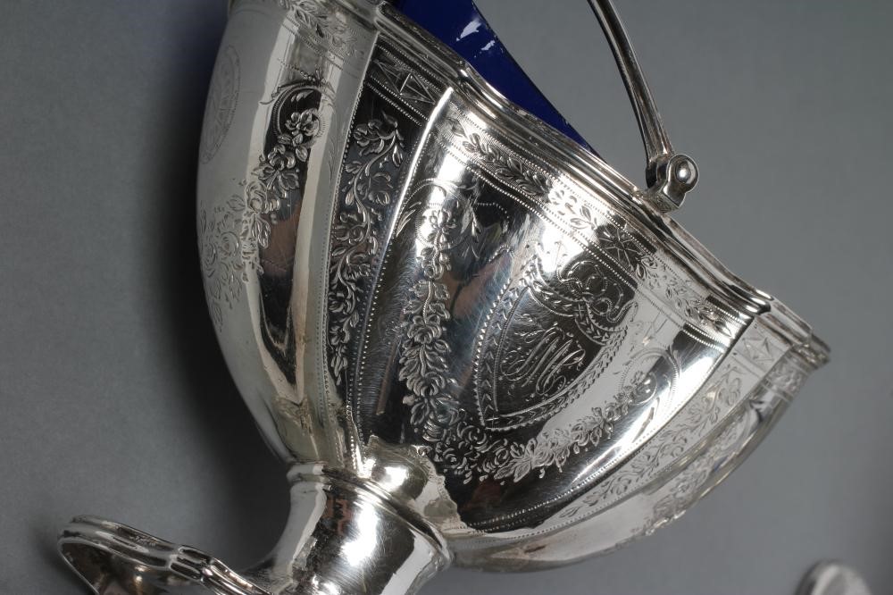 A GEORGE III SILVER SUGAR BASKET AND MATCHING CREAM BASKET Image