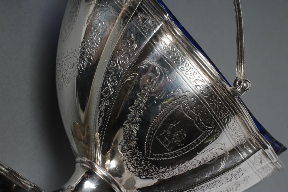 A GEORGE III SILVER SUGAR BASKET AND MATCHING CREAM BASKET Image