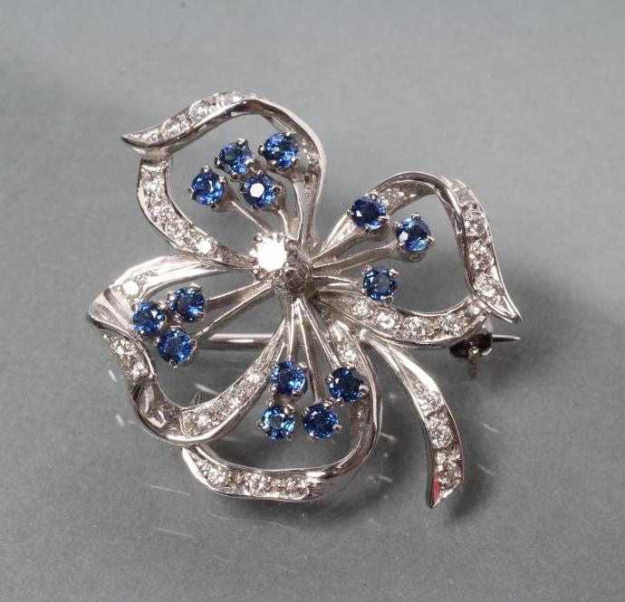 A SAPPHIRE AND DIAMOND OPEN FLOWER BROOCH with fourteen small circular cut sapphire stamens and Image