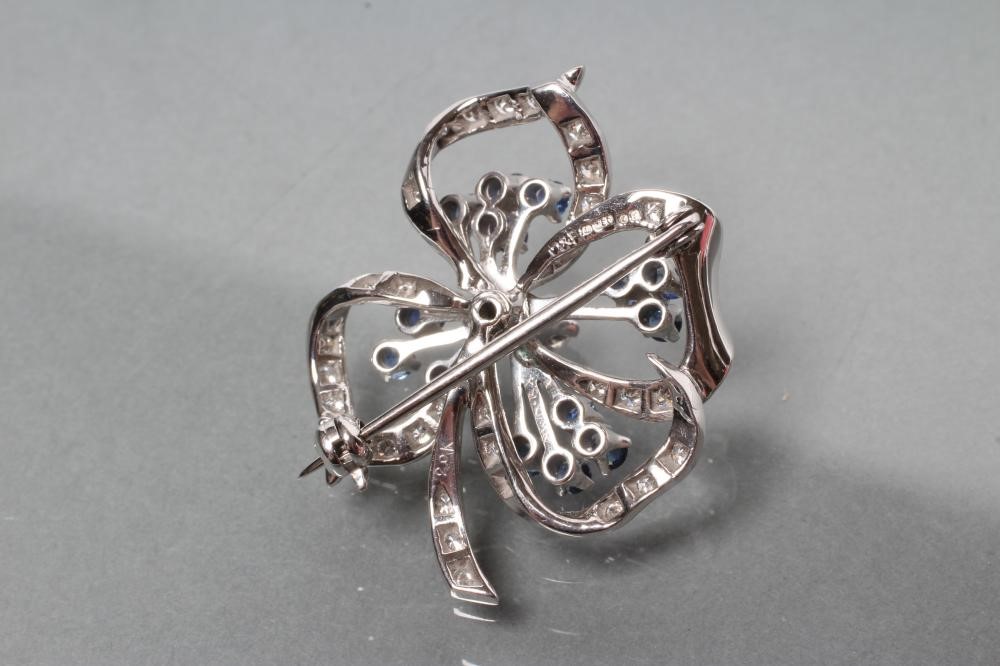 A SAPPHIRE AND DIAMOND OPEN FLOWER BROOCH with fourteen small circular cut sapphire stamens and Image