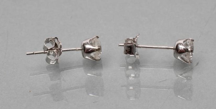 A PAIR OF SOLITAIRE DIAMOND EAR STUDS Image