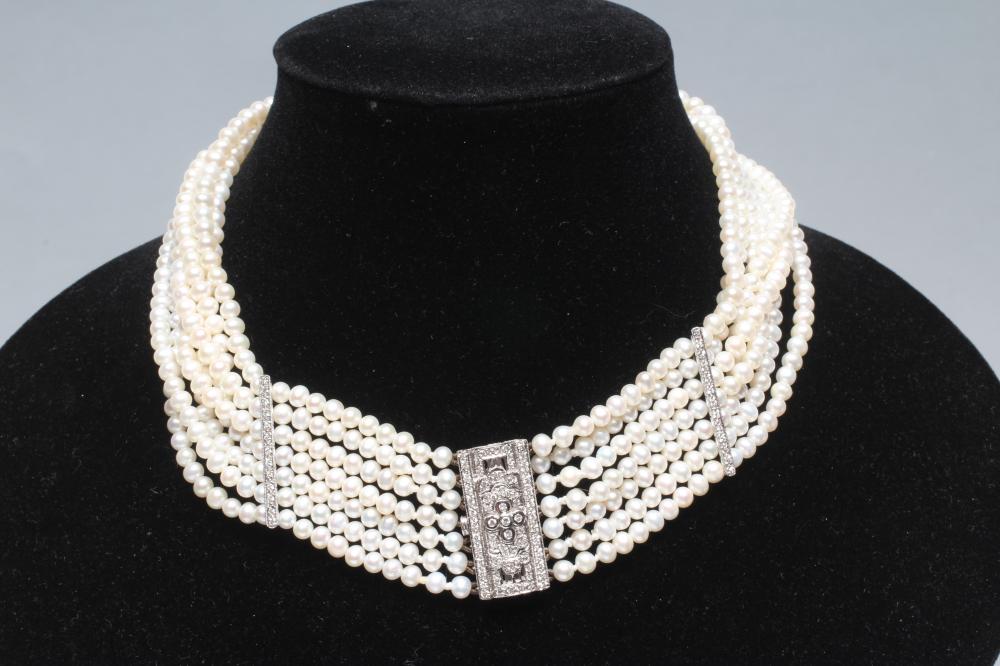 A SEVEN STRAND CULTURED PEARL CHOKER with two diamond set spacing bars to a white oblong clasp Image
