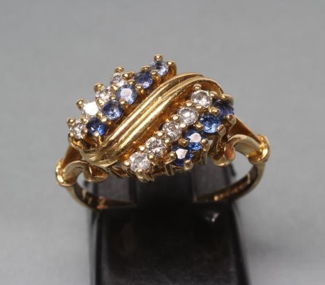 A DRESS RING claw set with nine small sapphires and nine small round brilliant cut diamonds Image