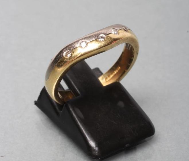 AN 18CT BI-COLOUR GOLD WISHBONE HALF ETERNITY RING Image