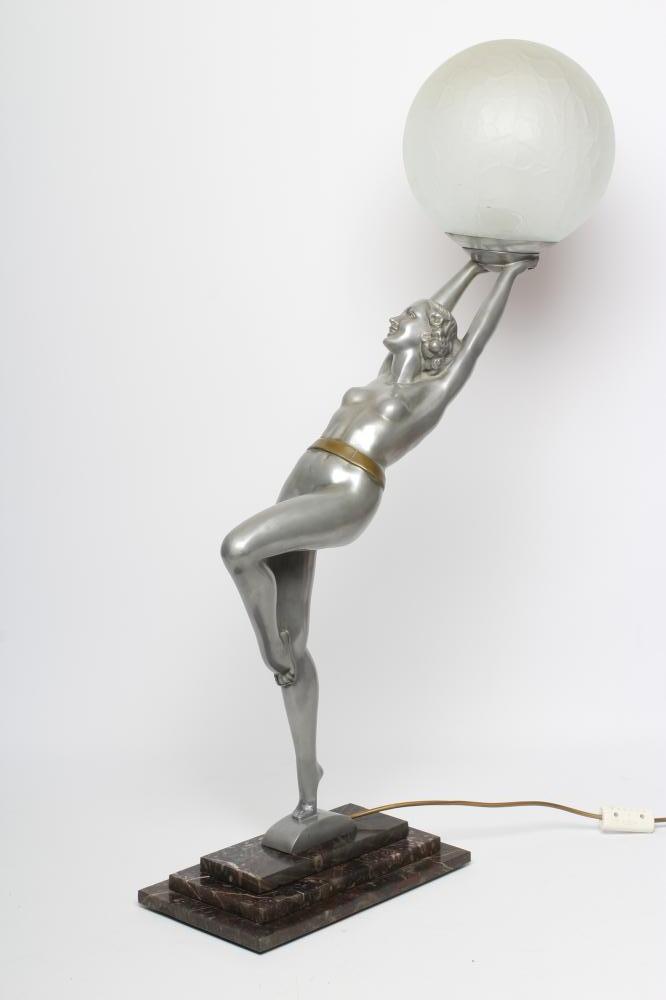 AFTER LORENZL - a large silvered metal figural lamp base modelled as a young female nude standing on Image