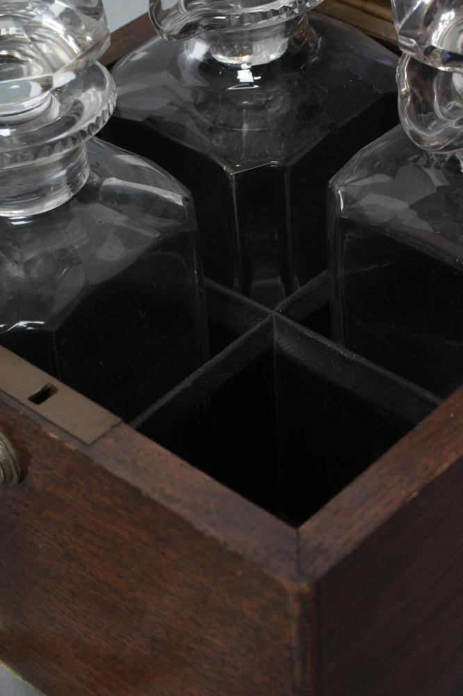 A LATE VICTORIAN OAK FOUR BOTTLE DECANTER BOX of square section with Bramah lock Image