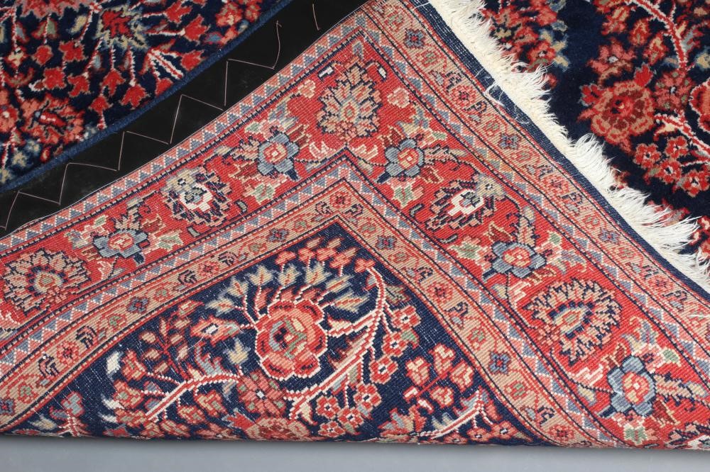 A PERSIAN WOOL RUG Image