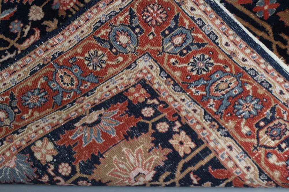 A PERSIAN WOOL RUG Image