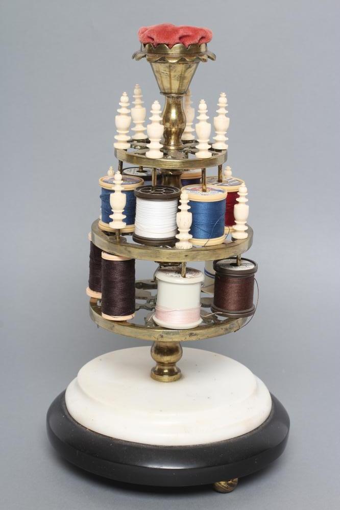 A VICTORIAN BRASS BOBBIN STAND comprising three graduated pierced trays with turned bone finials on Image