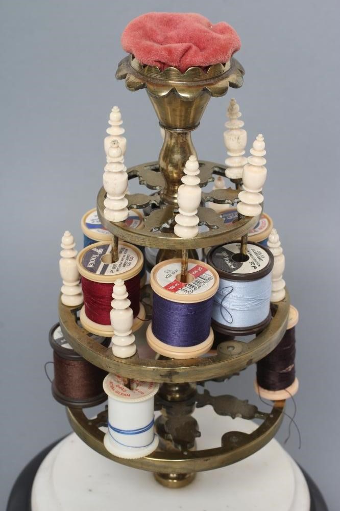 A VICTORIAN BRASS BOBBIN STAND comprising three graduated pierced trays with turned bone finials on Image