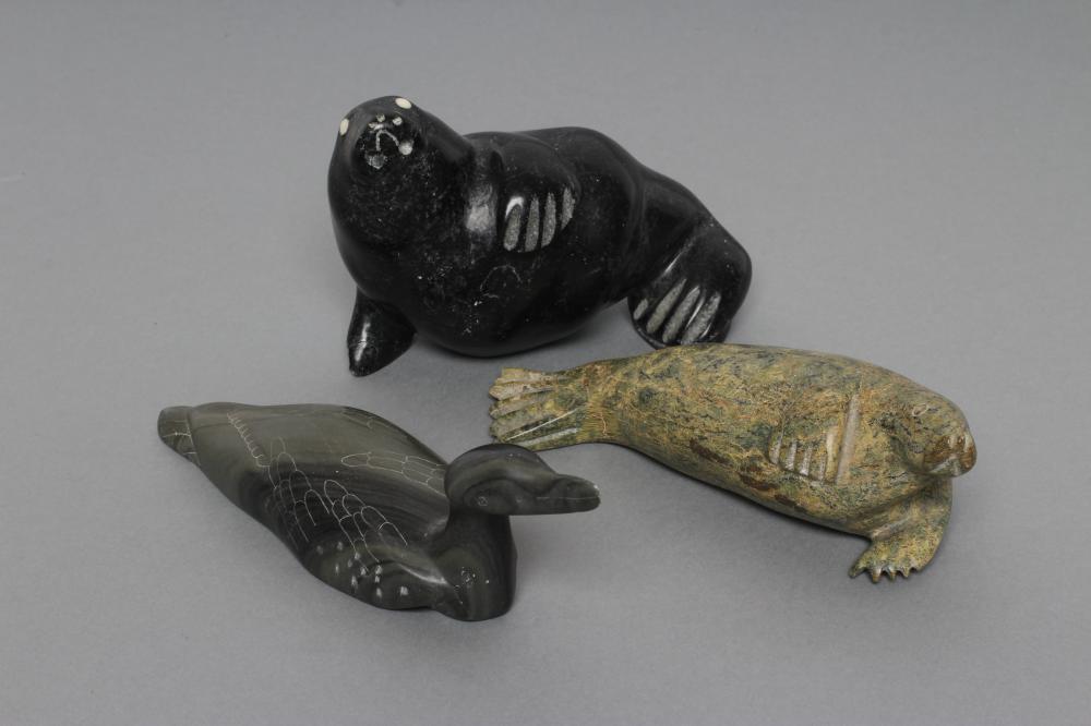 THREE INUIT STONE CARVINGS depicting a seal Image